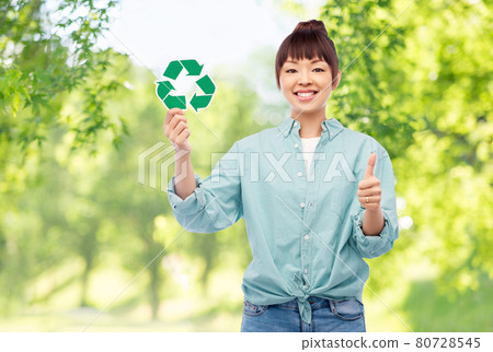 smiling asian woman holding green recycling sign smiling asian woman holding green recycling sign 80728545