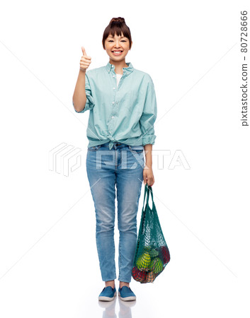woman with food in string bag showing thumbs up woman with food in string bag showing thumbs up 80728666