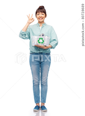 smiling young asian woman sorting metallic waste smiling young asian woman sorting metallic waste 80728689