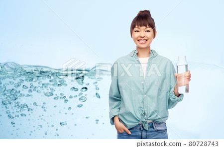 happy asian woman holding glass bottle with water 80728743