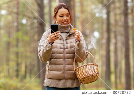asian woman using smartphone to identify mushroom 80728783