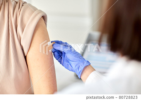 close up of doctor attaching patch to patient close up of doctor attaching patch to patient 80728823