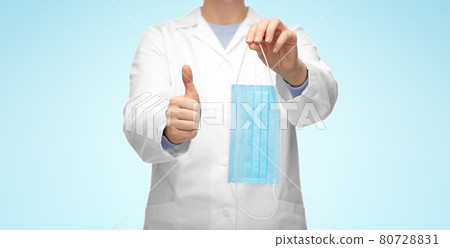 female doctor with medical mask showing thumbs up female doctor with medical mask showing thumbs up 80728831
