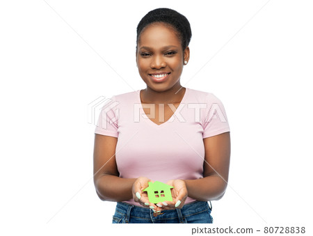 smiling african american woman holding green house 80728838