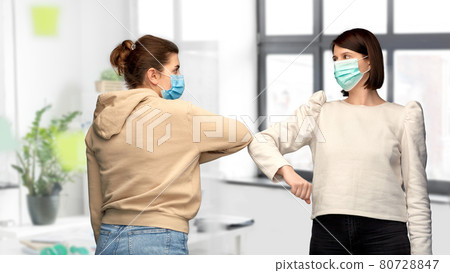 women in masks making elbow bump greeting gesture women in masks making elbow bump greeting gesture 80728847