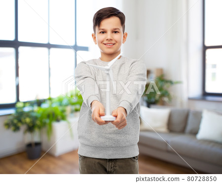 smiling boy with toy wind turbine smiling boy with toy wind turbine 80728850