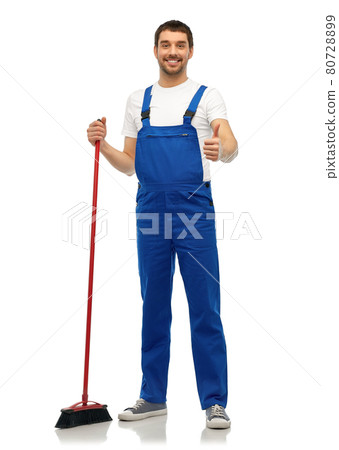 male cleaner in overall cleaning floor with broom 80728899