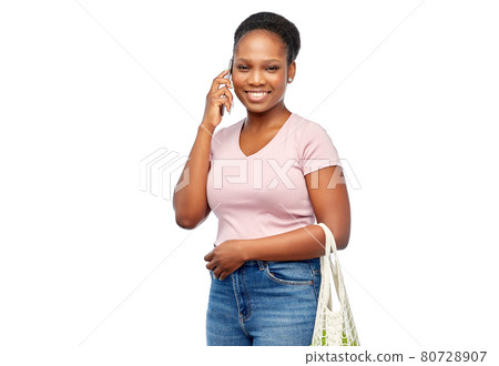 woman with food in net bag calling on smartphone woman with food in net bag calling on smartphone 80728907