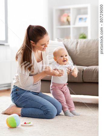 happy mother playing with little baby at home 80729000
