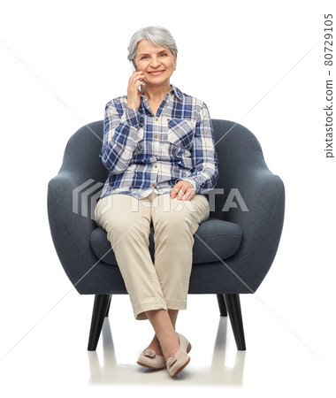 senior woman calling on smartphone in armchair senior woman calling on smartphone in armchair 80729105