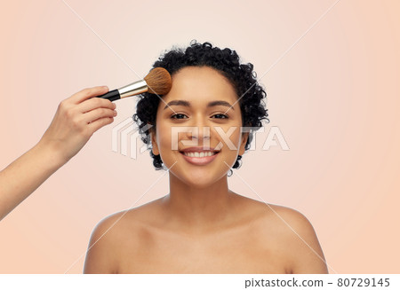 happy woman and hand of make up artist with brush happy woman and hand of make up artist with brush 80729145