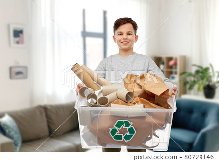 smiling boy sorting paper waste smiling boy sorting paper waste 80729146
