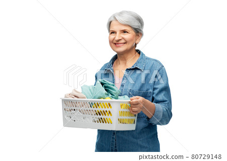 smiling senior woman with laundry basket 80729148