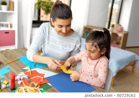 daughter with mother making applique at home daughter with mother making applique at home 80729162