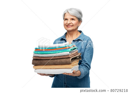 smiling senior woman with clean bath towels smiling senior woman with clean bath towels 80729218