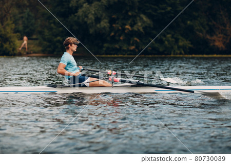 Sportsman single scull man rower rowing on boat 80730089