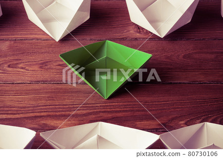 Business leadership concept with white and color paper boats on 80730106