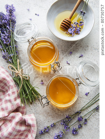 Jars with honey and fresh lavender flowers Jars with honey and fresh lavender flowers 80730757