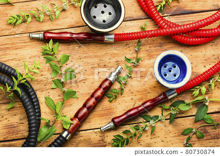 Smoking hookah with fresh mint Smoking hookah with fresh mint 80730874