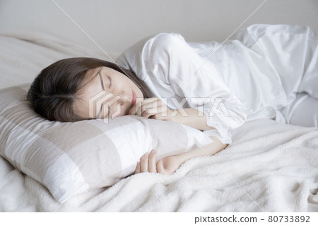 A woman sleeping in bed A woman sleeping in bed 80733892