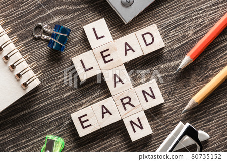 Conceptual business keywords on table with elements of game making crossword 80735152