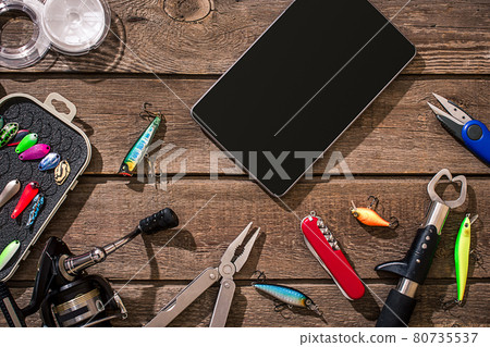 Accessories for fishing on the background of wood. Top view 80735537