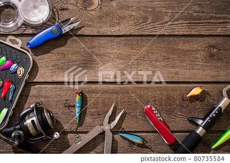 Accessories for fishing on the background of wood. Top view 80735584