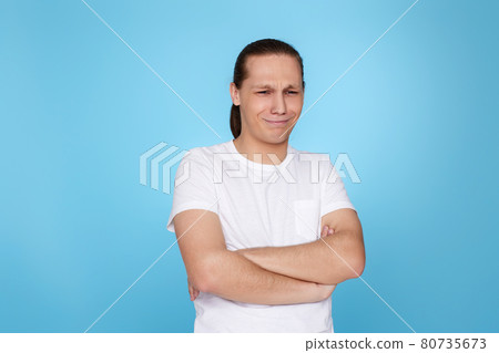 young man frowning isolated on blue background. young man frowning isolated on blue background. 80735673