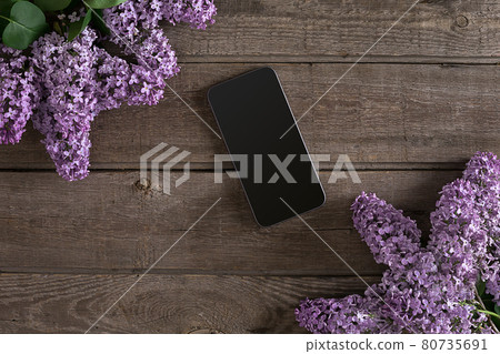 Lilac blossom on rustic wooden background, smart with empty space for greeting message. Top view Lilac blossom on rustic wooden background, smart with empty space for greeting message. Top view 80735691