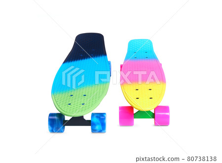 Two rainbow plastic Penny board skateboards on white background 80738138