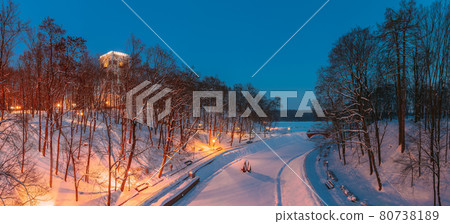 Gomel, Belarus. City Park In Winter Night. Clock Tower Of Rumyantsevs And Paskeviches Palace And Frozen Pond In Homiel Park, Belarus. Famous Local Landmark In Snow. Panorama 80738189
