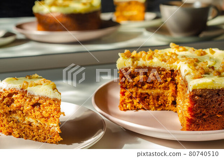 Delicious carrot cake filled and topped with cream cheese buttercream and decorated with walnuts Delicious carrot cake filled and topped with cream cheese buttercream and decorated with walnuts 80740510