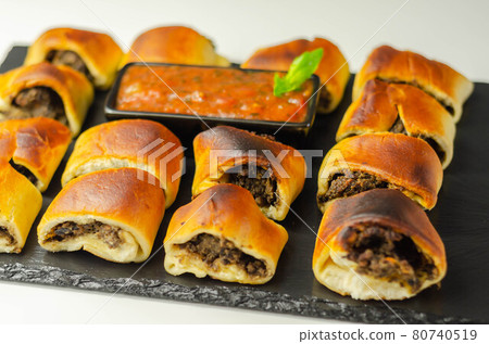 Patty's pies stuffed with minced meat, mushrooms and onion, served with sauce Patty's pies stuffed with minced meat, mushrooms and onion, served with sauce 80740519