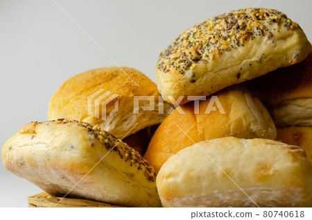 Various types of bread served on a wicker tray, delicious and fresh rolls Various types of bread served on a wicker tray, delicious and fresh rolls 80740618