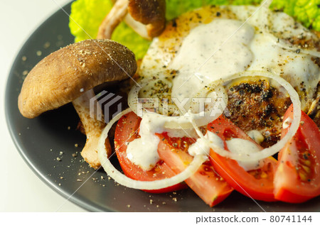 The fried portion of gammon served with egg, fresh lettuce, tomato, onion and funguses The fried portion of gammon served with egg, fresh lettuce, tomato, onion and funguses 80741144