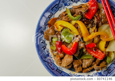 Cooked marinated beef slices with a savory black beef sauce, peppers and onions Cooked marinated beef slices with a savory black beef sauce, peppers and onions 80741146