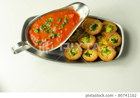 Mini scotch eggs with tomato sauce served on the silver plate 80741182