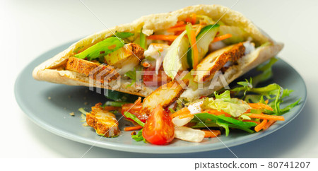 Mediterranean style pitta prepared with spicy chicken, cucumber, tomato, salad and mayo sauce Mediterranean style pitta prepared with spicy chicken, cucumber, tomato, salad and mayo sauce 80741207