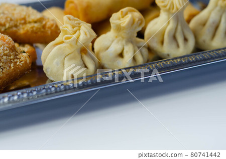 Sweet and sour vegetable wontons, Traditional chinese dumplings filled with bean sprouts, red bell peppers, carrot, cabbage and spring onions 80741442