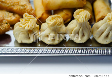 Sweet and sour vegetable wontons, Traditional chinese dumplings filled with bean sprouts, red bell peppers, carrot, cabbage and spring onions 80741443
