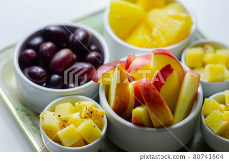 Various set fruits, pineapple, apple, grapes with matured cheddar cheese in bowls 80741804
