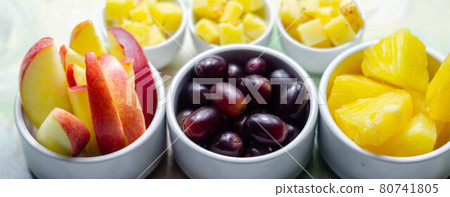 Various set fruits, pineapple, apple, grapes with matured cheddar cheese in bowls Various set fruits, pineapple, apple, grapes with matured cheddar cheese in bowls 80741805