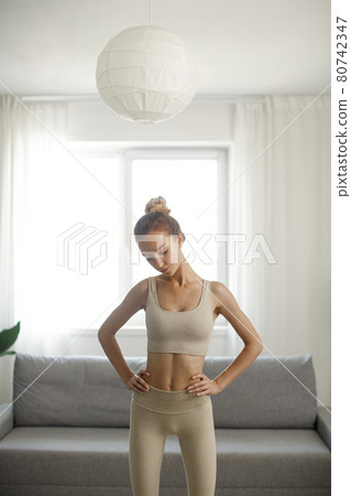 Sporty Woman after Workout at Home Indoors 80742347