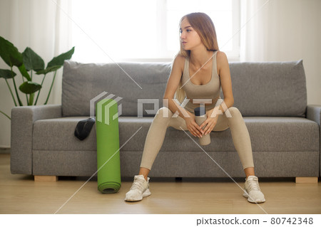 Sporty Woman on Yoga Mat at Home 80742348