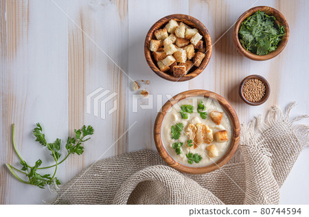 White cauliflower cream soup with croutons on wooden table with copy space White cauliflower cream soup with croutons on wooden table with copy space 80744594
