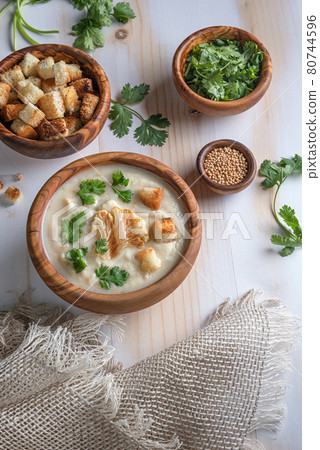 Homemade white cauliflower cream soup with croutons on wooden table Homemade white cauliflower cream soup with croutons on wooden table 80744596