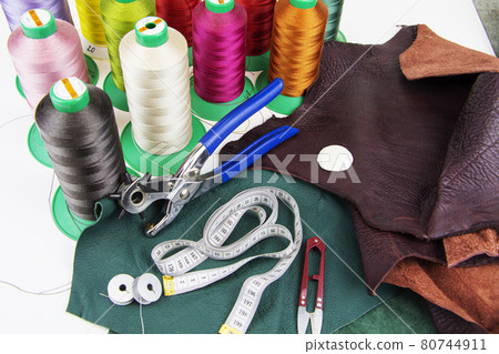 A piece of leather with scissors, needles, chalk, 80744911