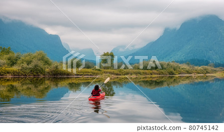 Adventure Caucasian Adult Woman Kayaking in Red Kayak 80745142