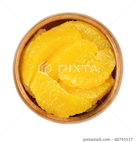 Orange slices supreme, in a wooden bowl. Fresh, ripe orange segments, cut without membranes, sweet fruit with juicy, yellow fruit flesh. Close-up from above, isolated on white background, food photo. Orange slices supreme, in a wooden bowl. Fresh, ripe orange segments, cut without membranes, sweet fruit with juicy, yellow fruit flesh. Close-up from above, isolated on white background, food photo. 80745517