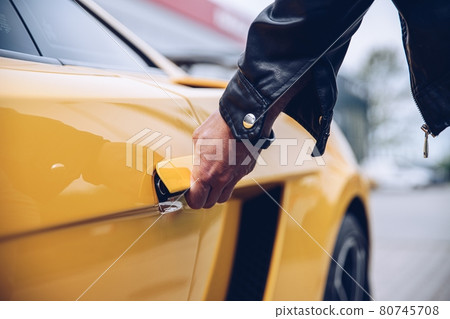 Man is reaching for the car door handle Man is reaching for the car door handle 80745708